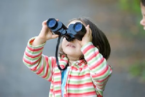 Girl Looking through Binoculars.
